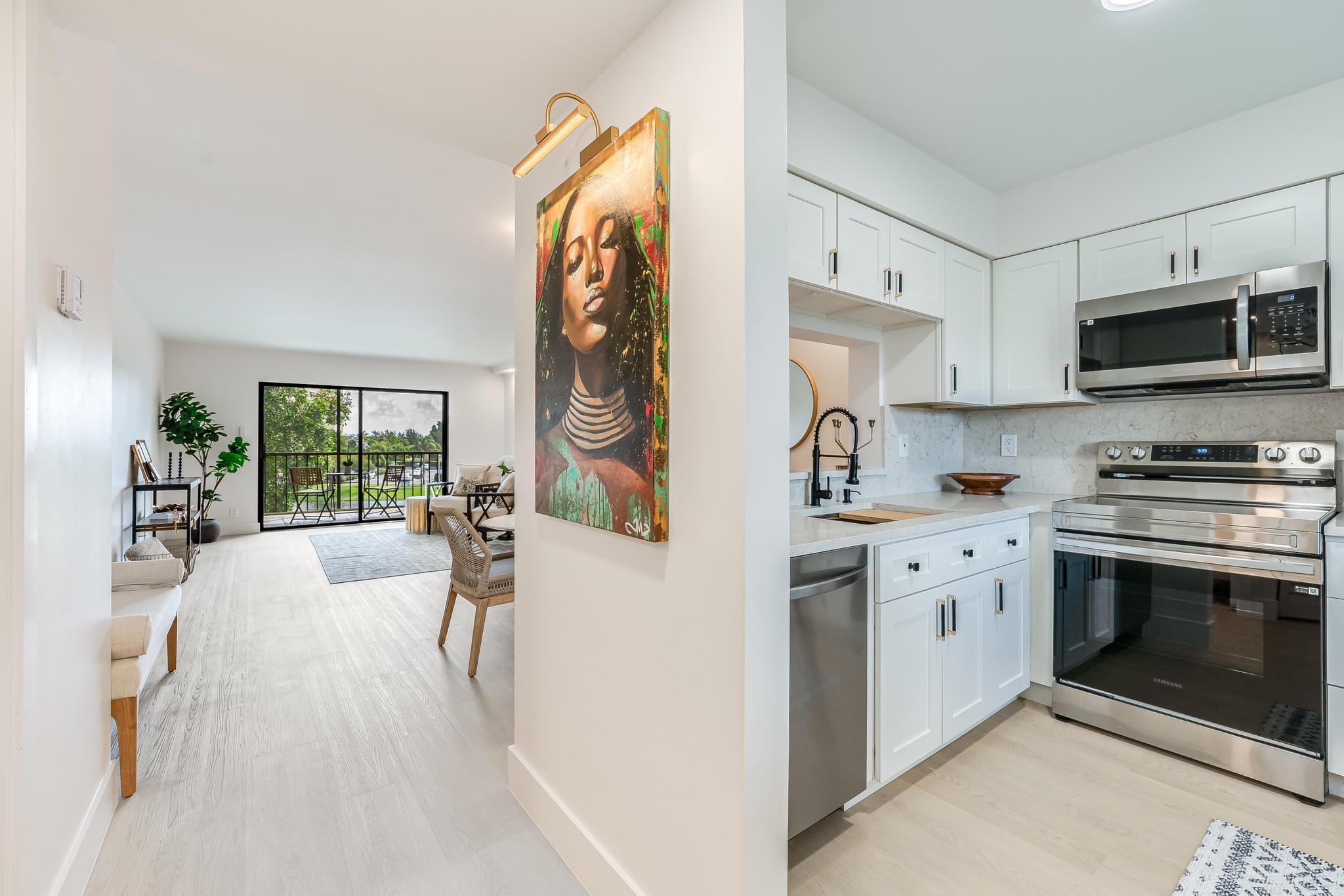 a kitchen with stainless steel appliances a stove a sink and a microwave