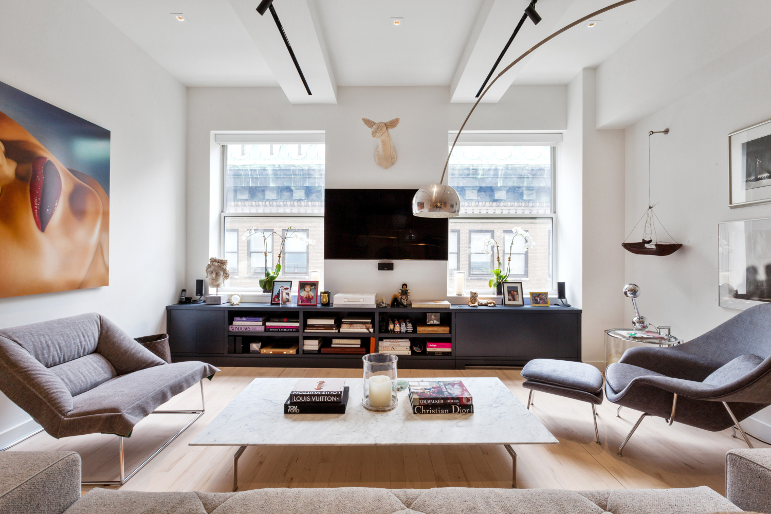 a living room with furniture fireplace and a large window