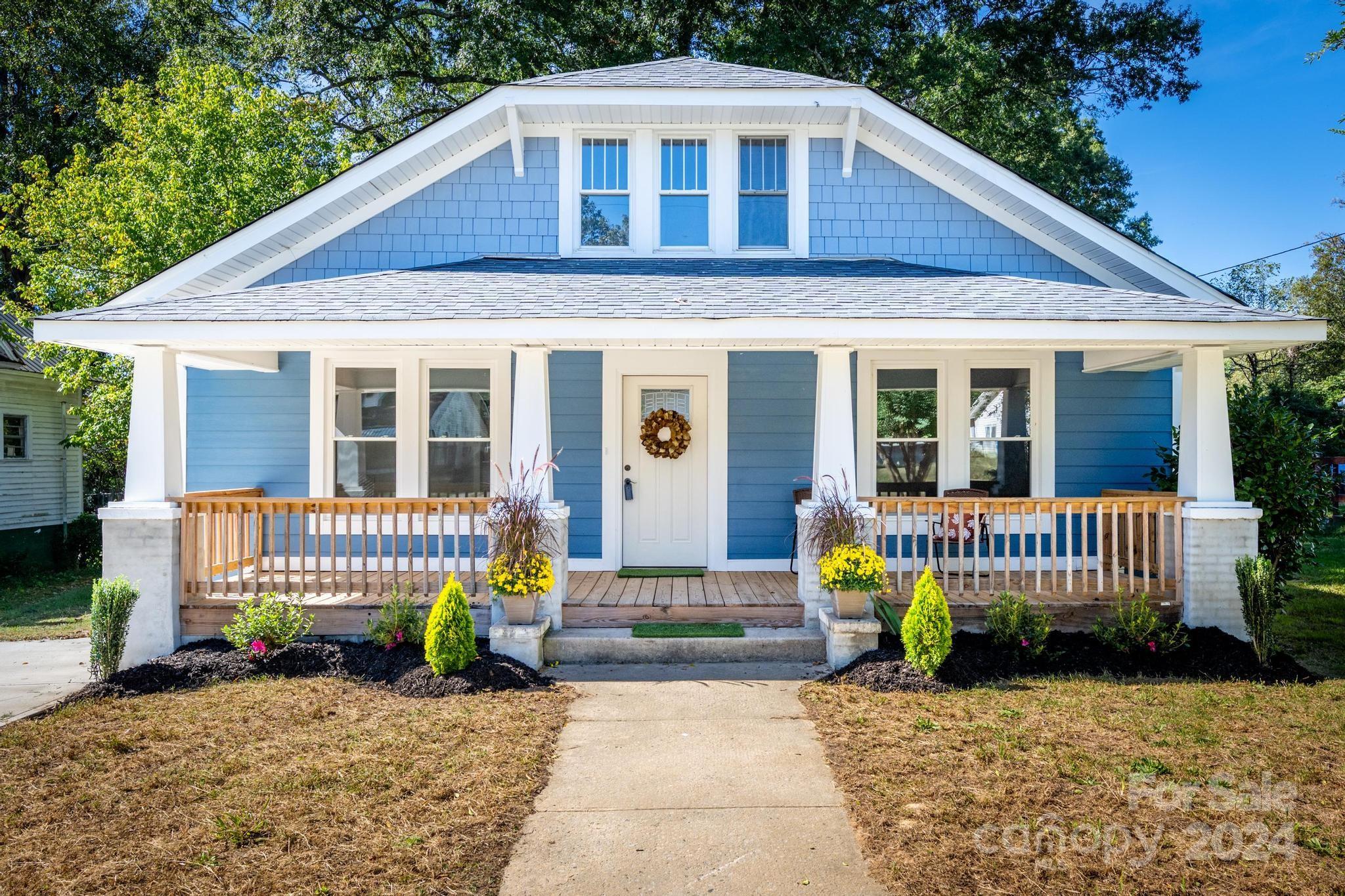 a front view of a house with a garden