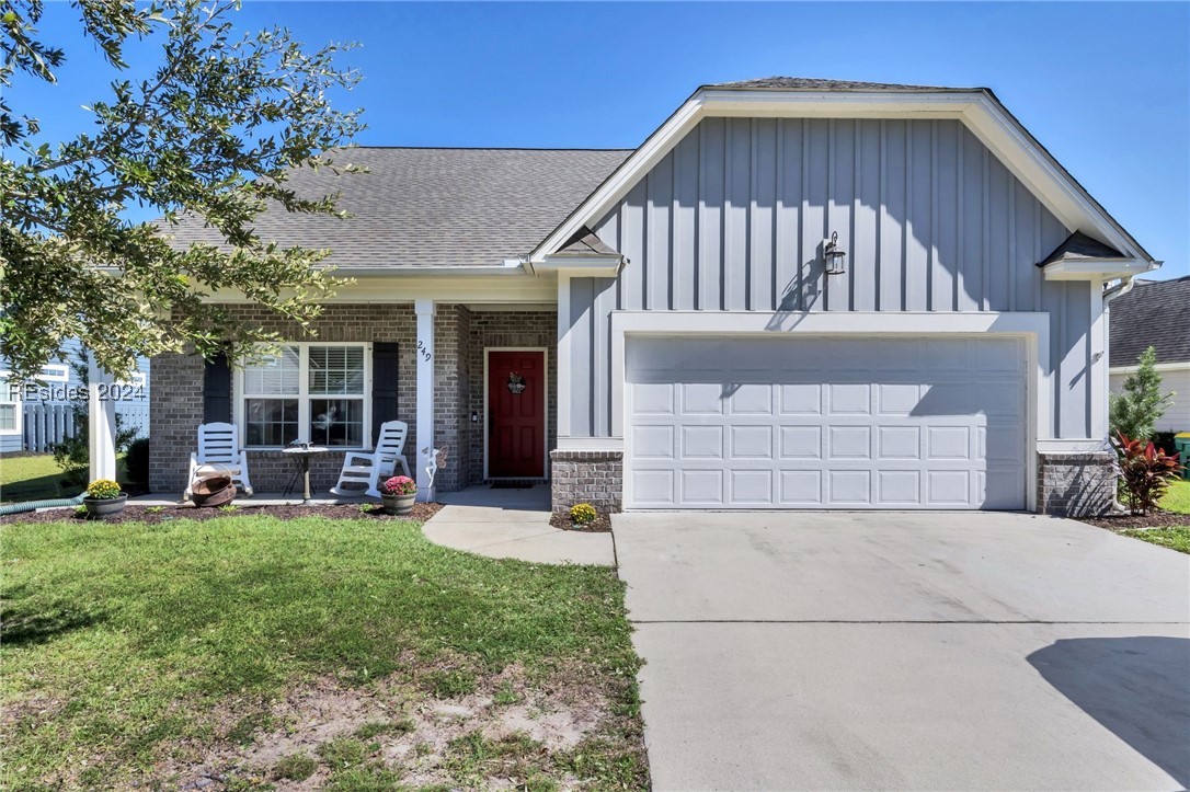 View of front of home with a garage, a porch, and