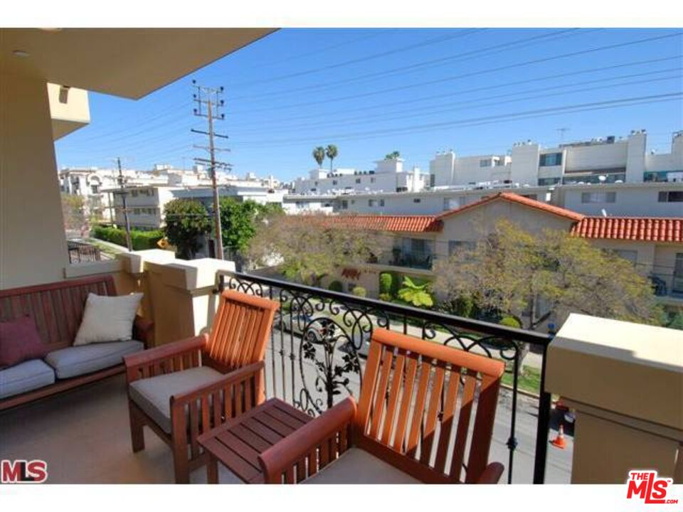 a view of balcony with furniture