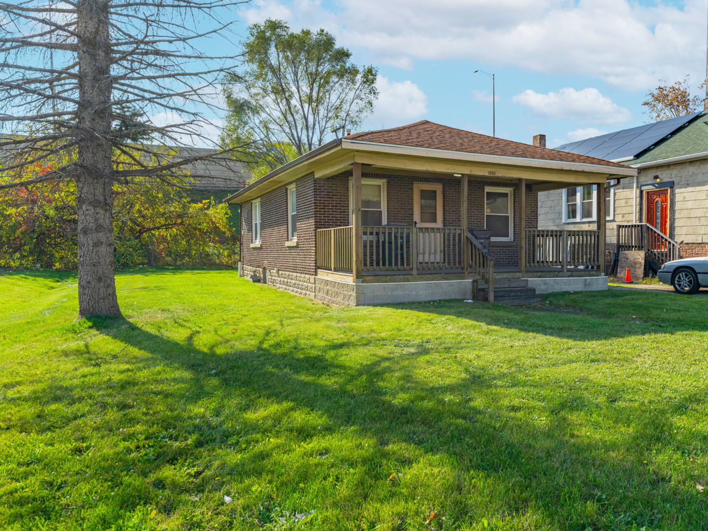 a front view of a house with yard and green space