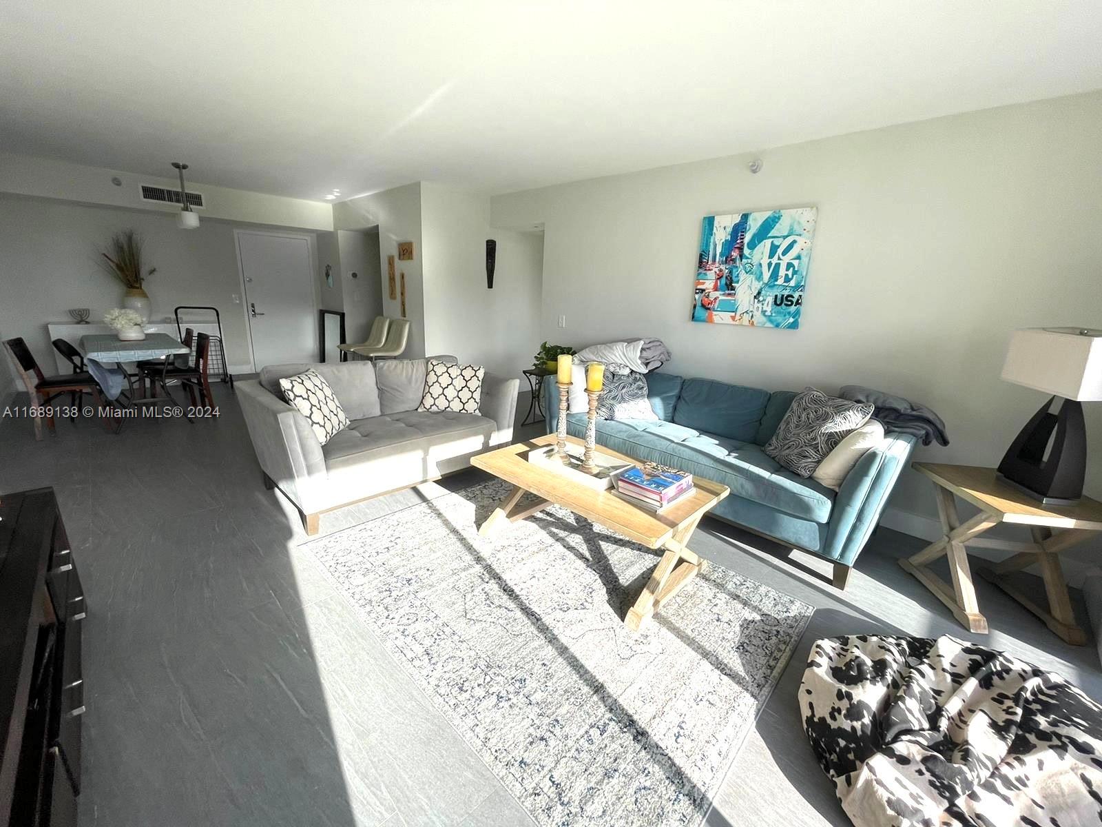 a living room with furniture and a rug