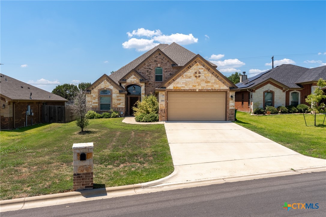 a front view of a house with a yard and garage