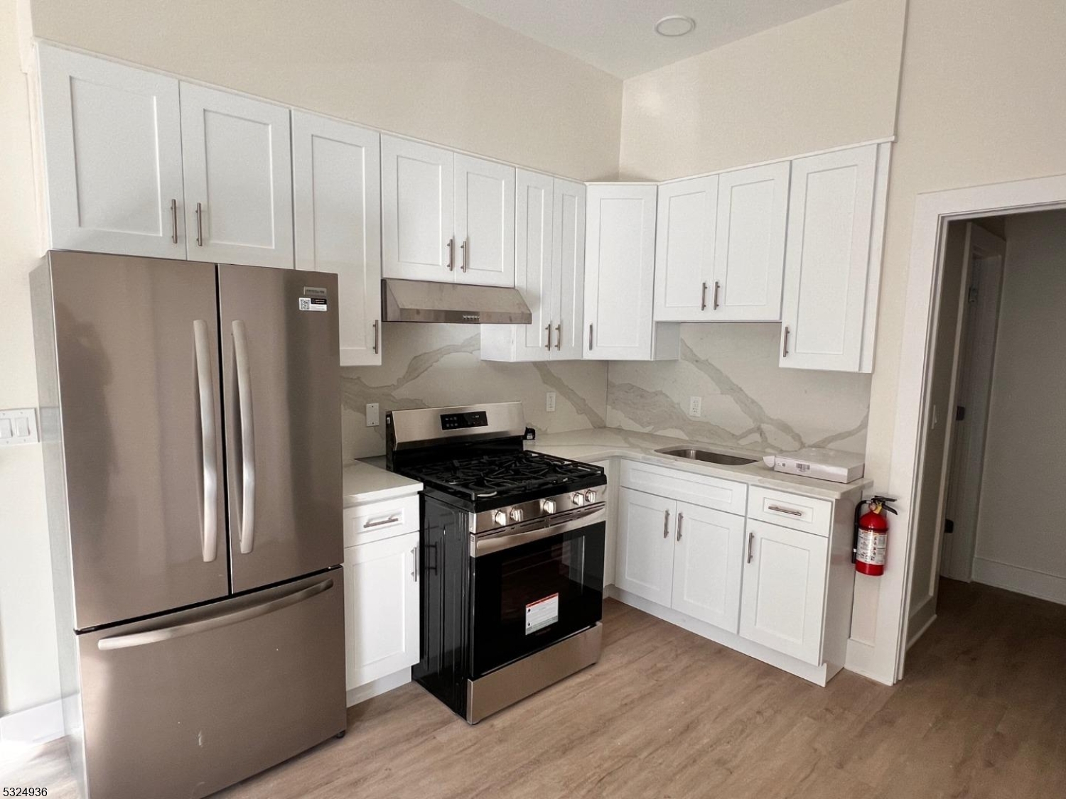 a kitchen with stainless steel appliances granite countertop a stove a refrigerator and a refrigerator