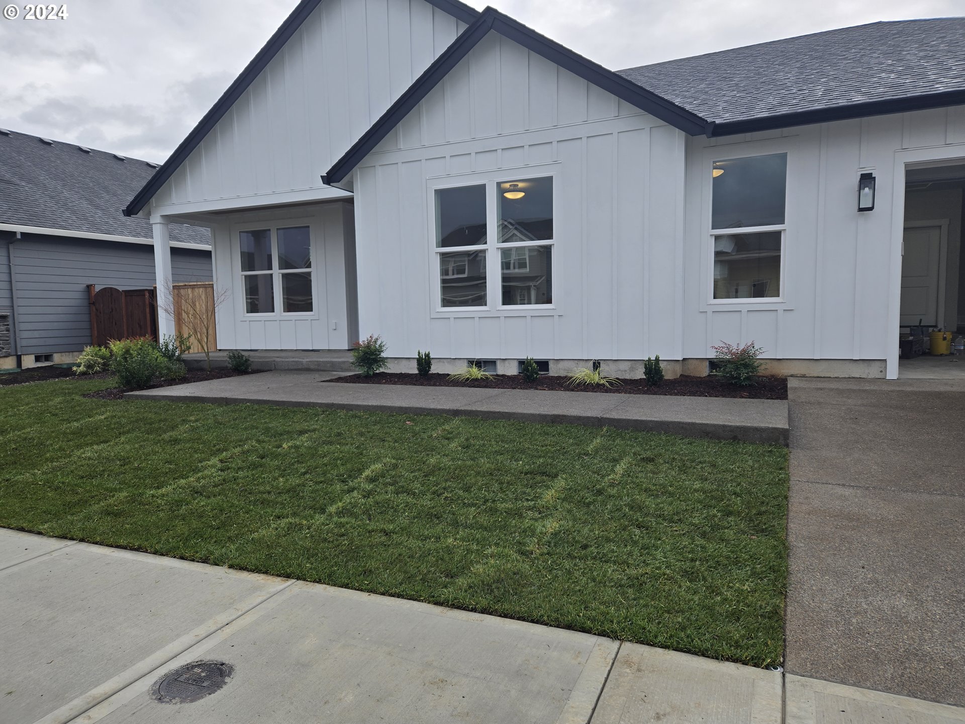 a front view of a house with a garden and yard