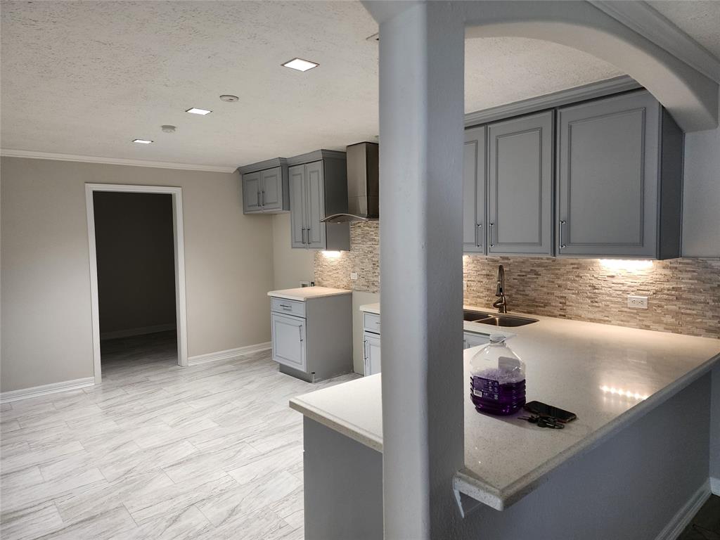 a kitchen with stainless steel appliances granite countertop a sink and a refrigerator