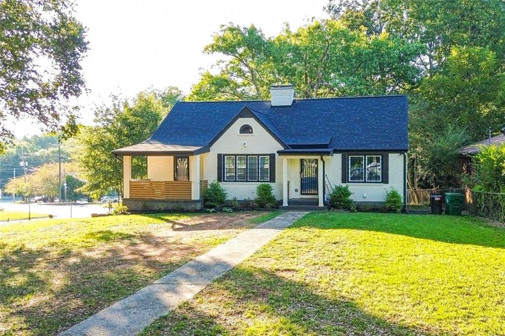 a front view of a house with a yard and trees