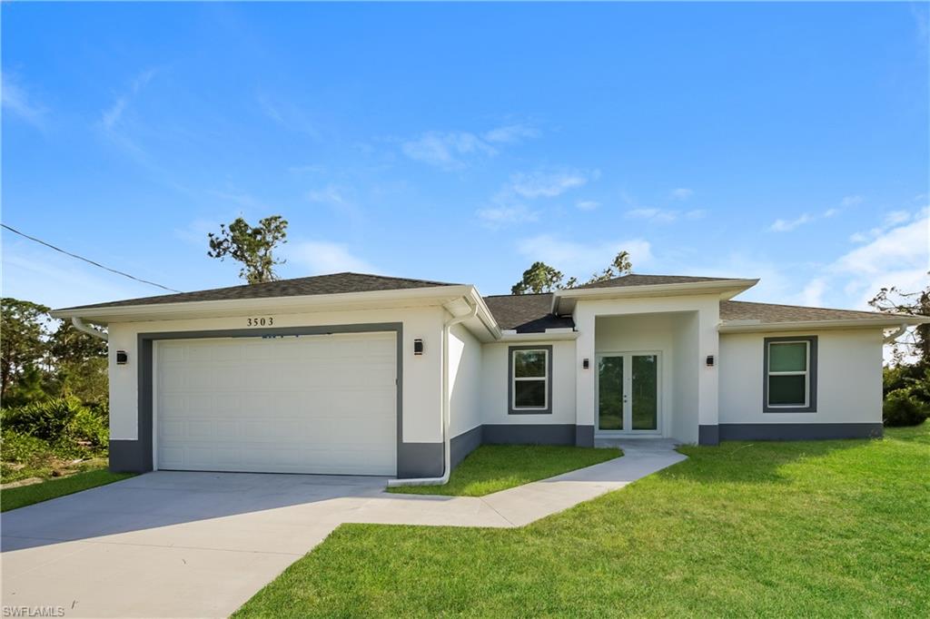 a front view of a house with a yard and garage