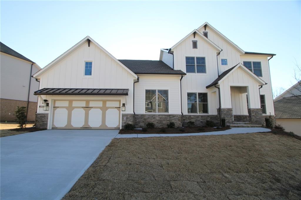 a front view of a house with a yard and garage