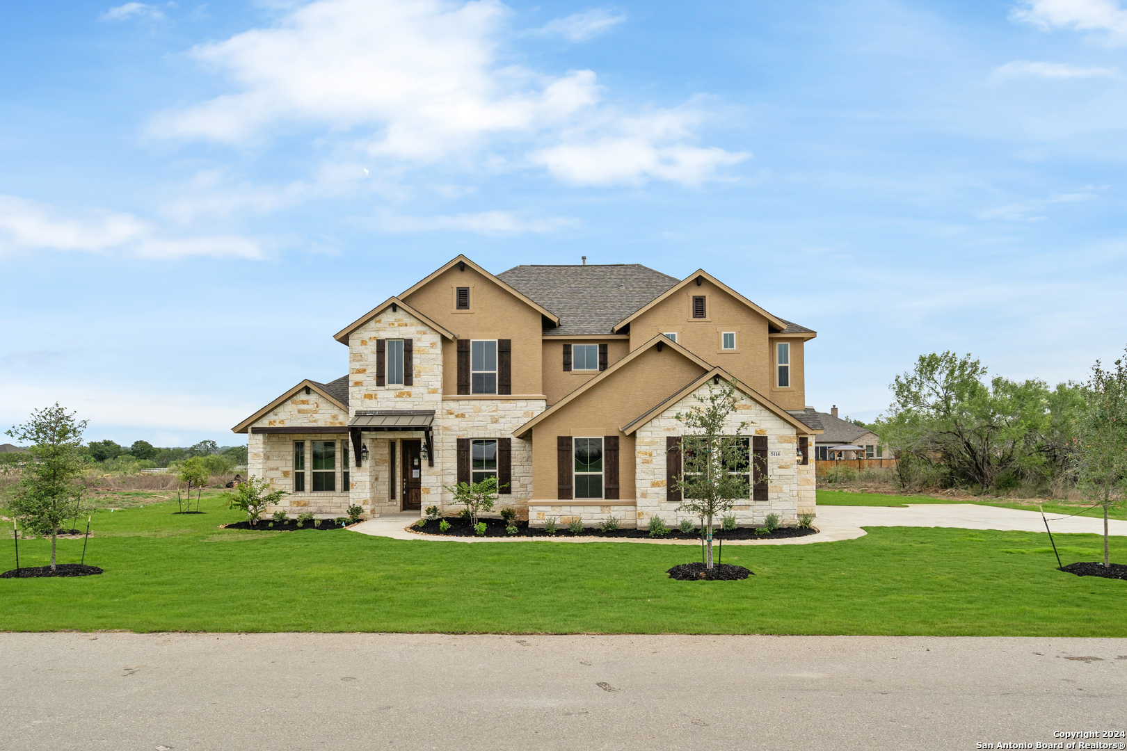 a front view of a house with a yard