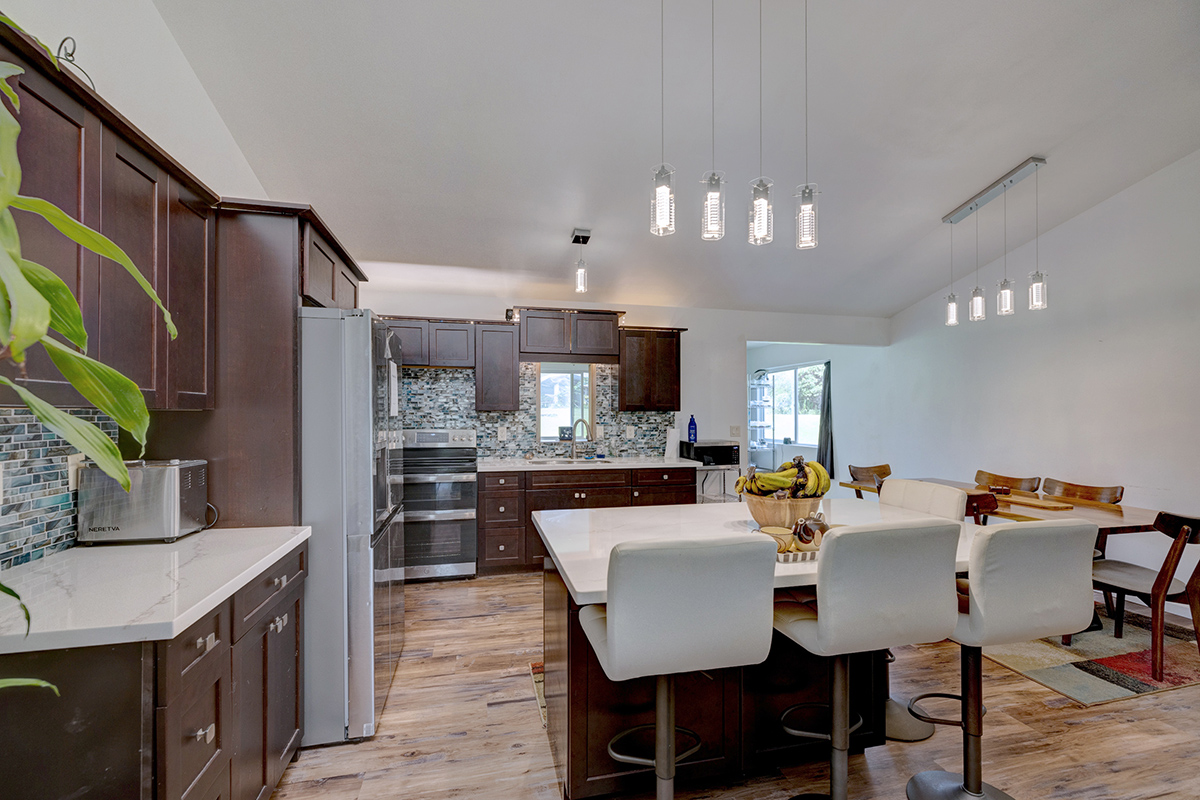 a view of a dining room with furniture and a kitchen