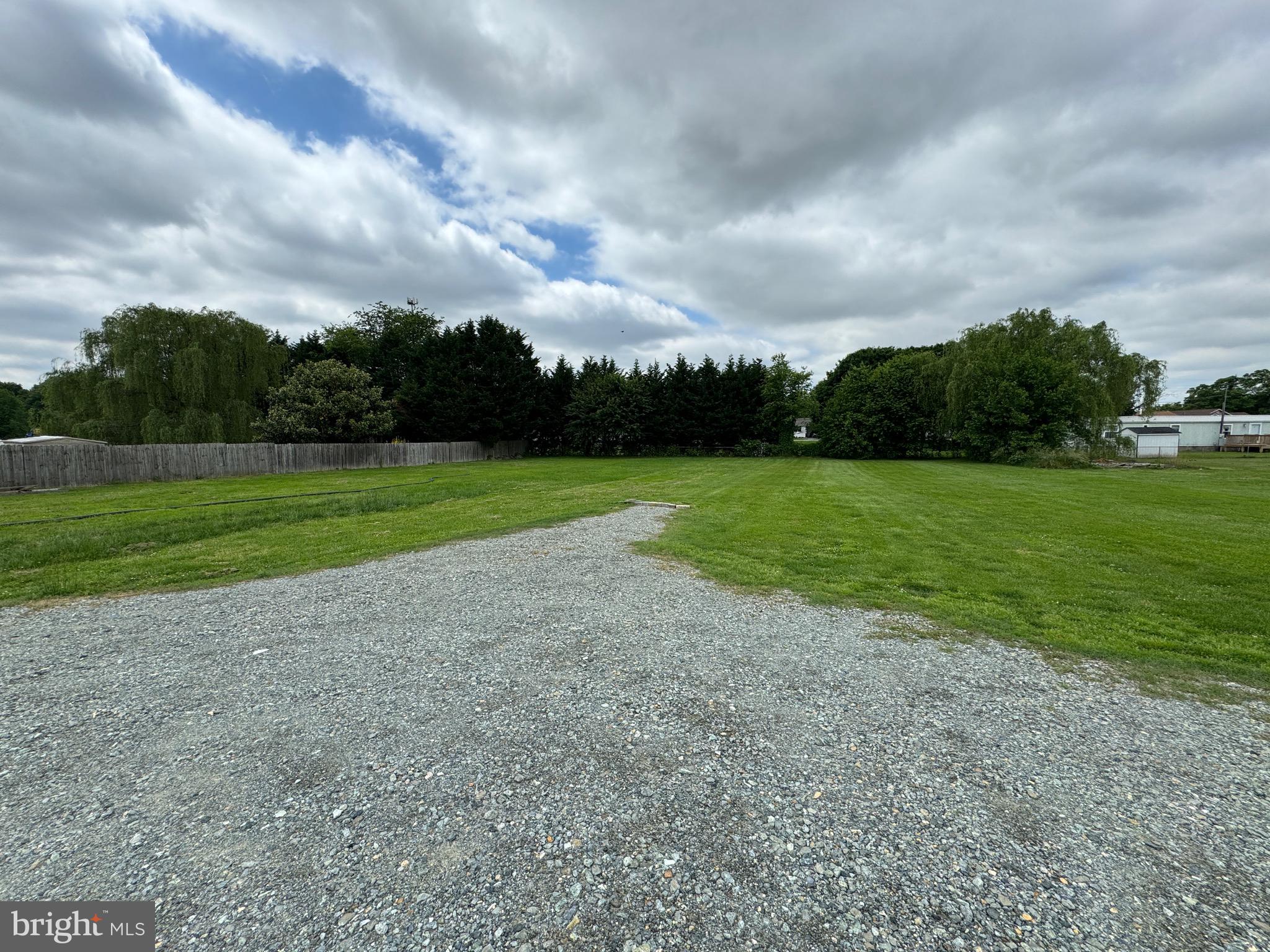 a view of a field and trees in the background