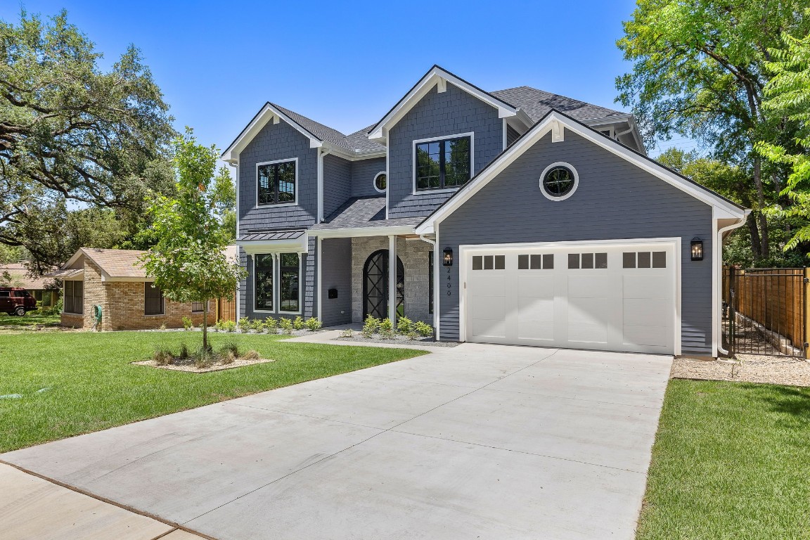 a front view of a house with a yard and garage