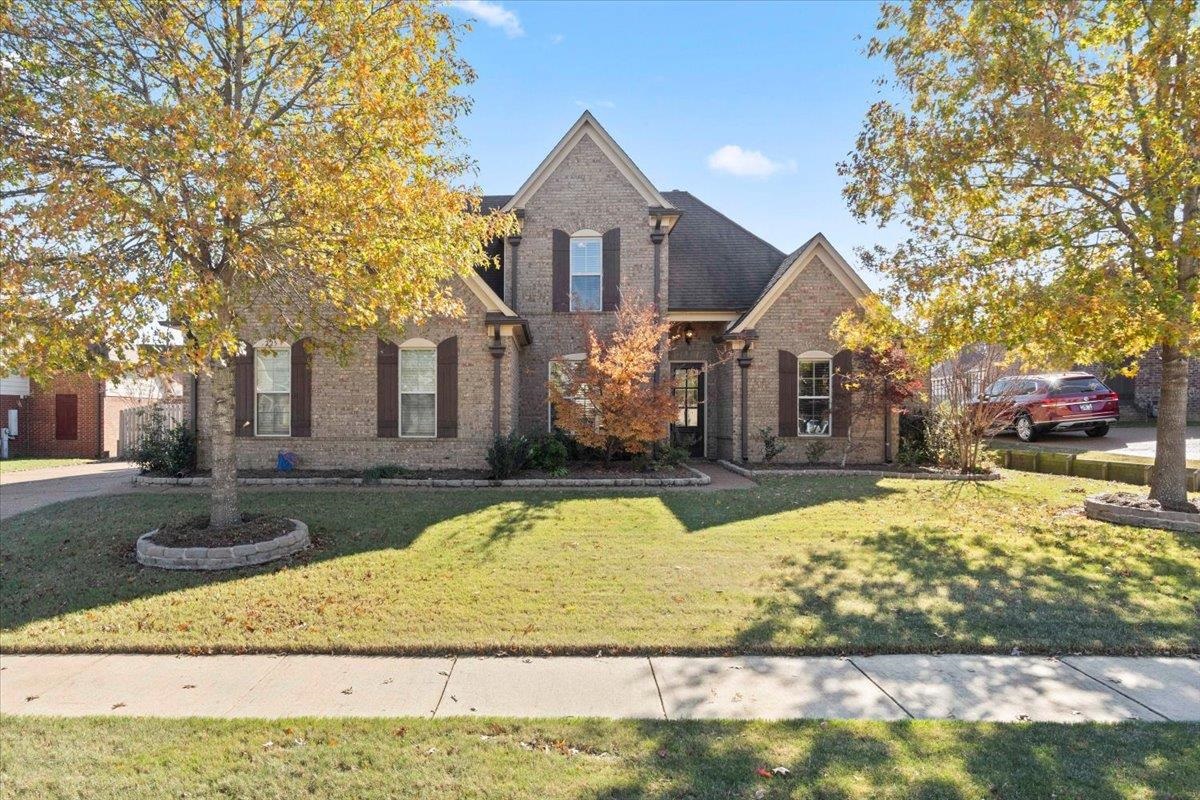 View of property with a front lawn