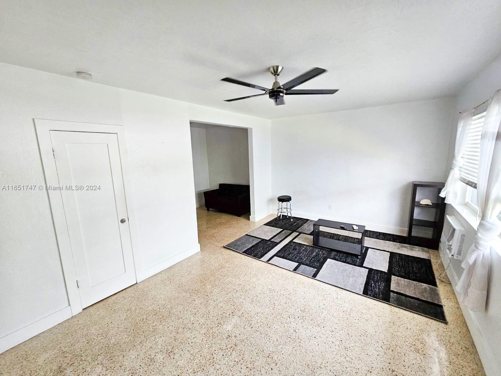 a bedroom with a bed and a ceiling fan