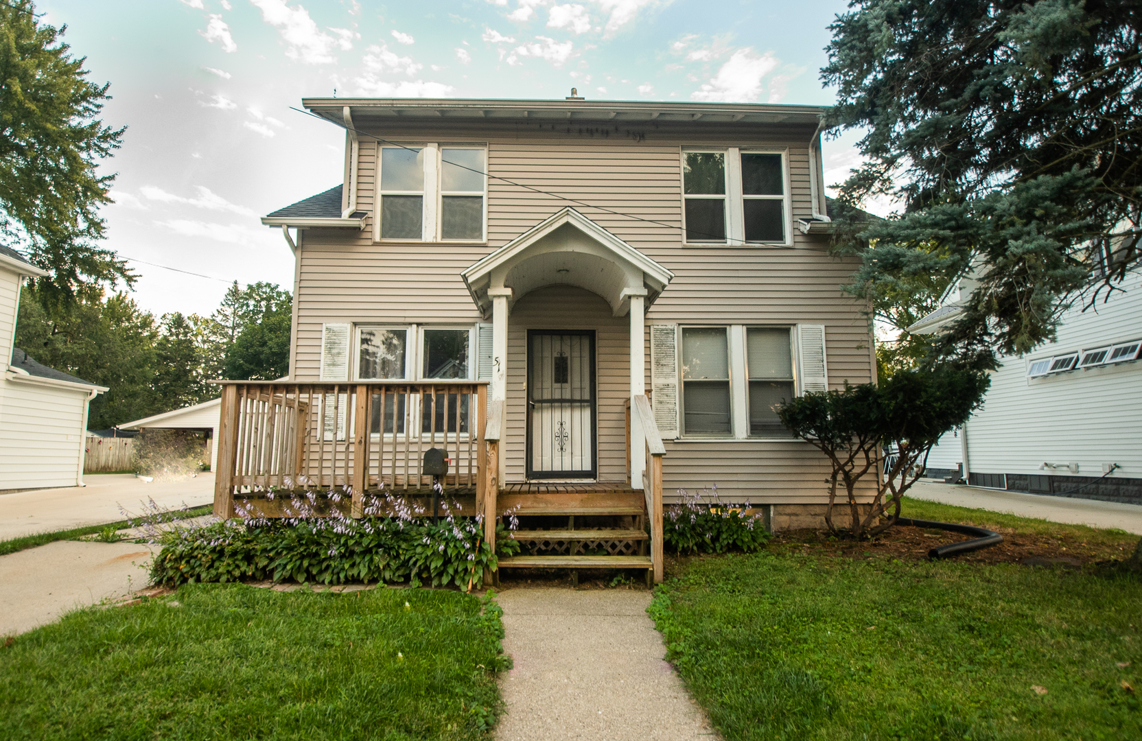 a front view of a house with a garden