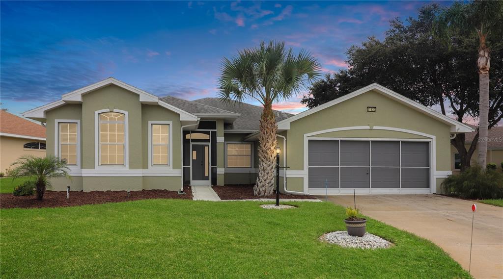 a front view of a house with a yard and garage