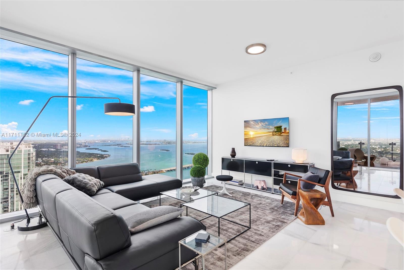 a living room with furniture city view and large windows