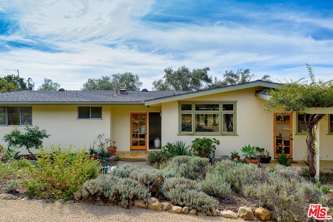 front view of a house with a garden