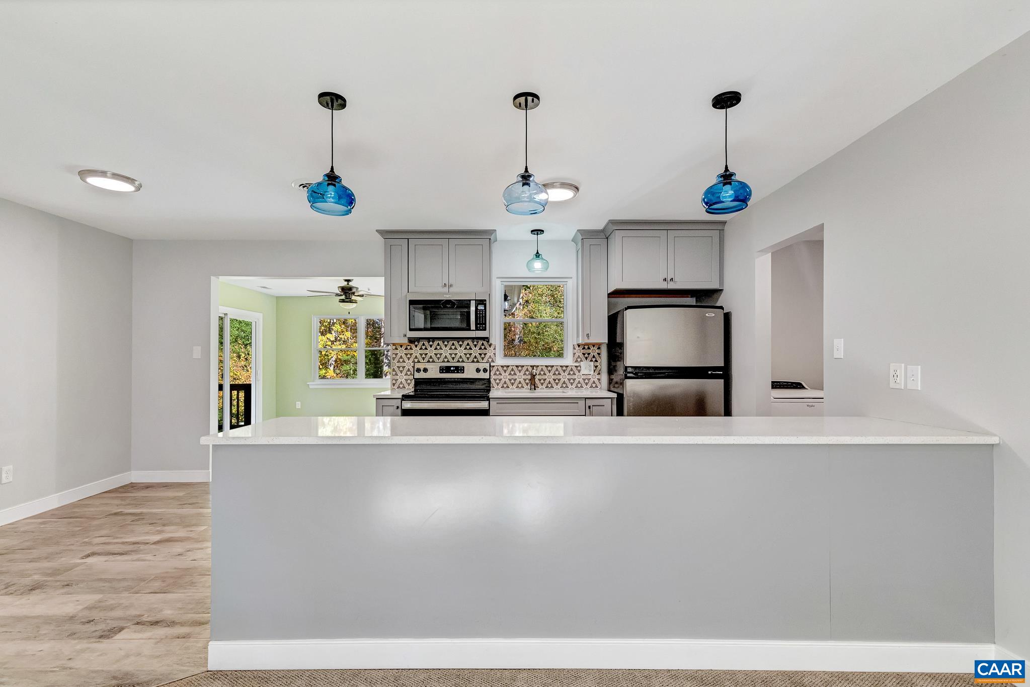 a kitchen with stainless steel appliances granite countertop a sink a stove and a refrigerator