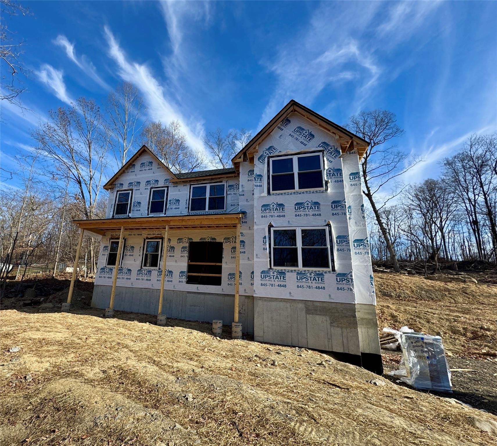 a front view of a house with yard and parking