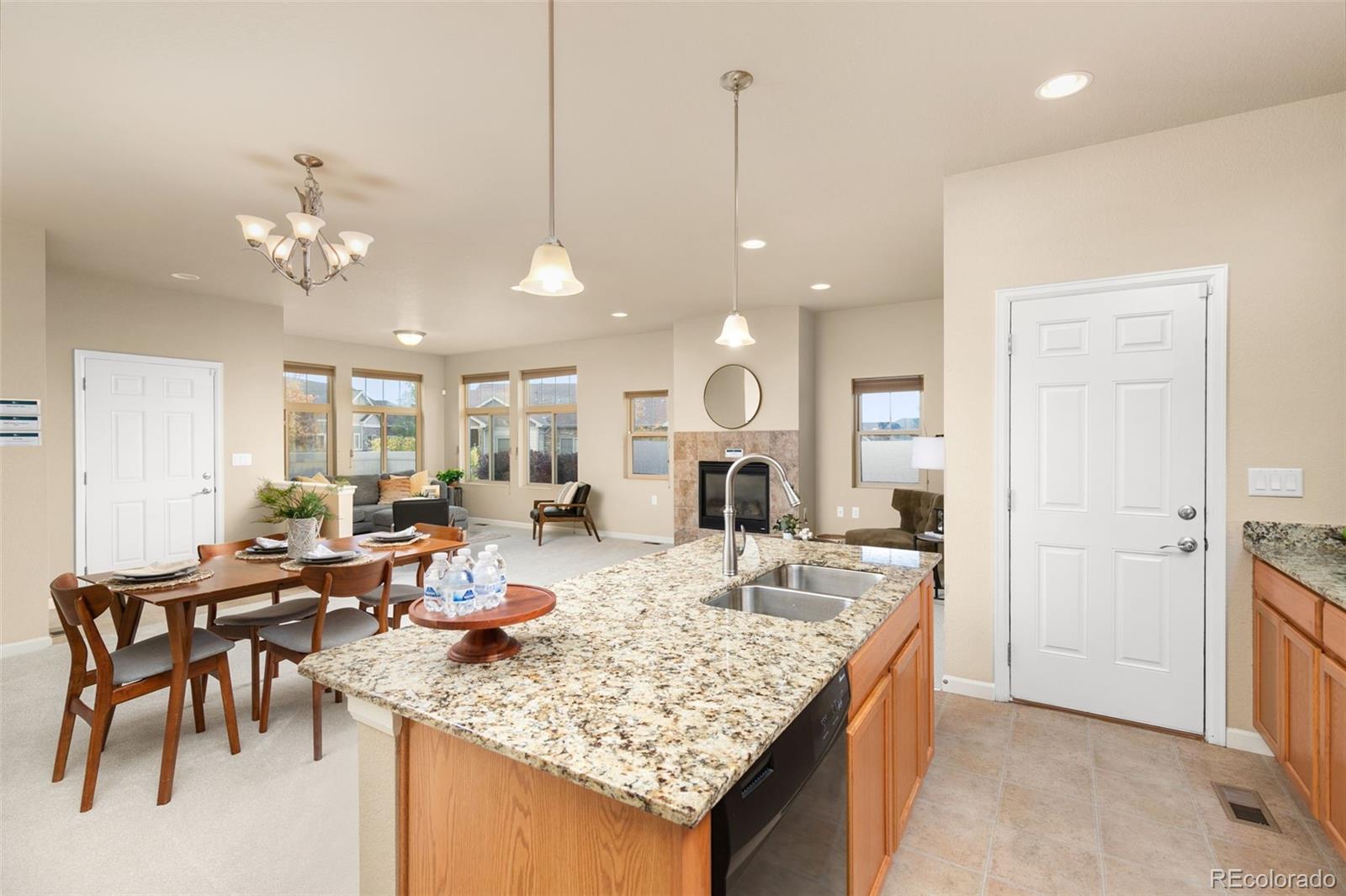 a kitchen island with granite countertop a table and chairs