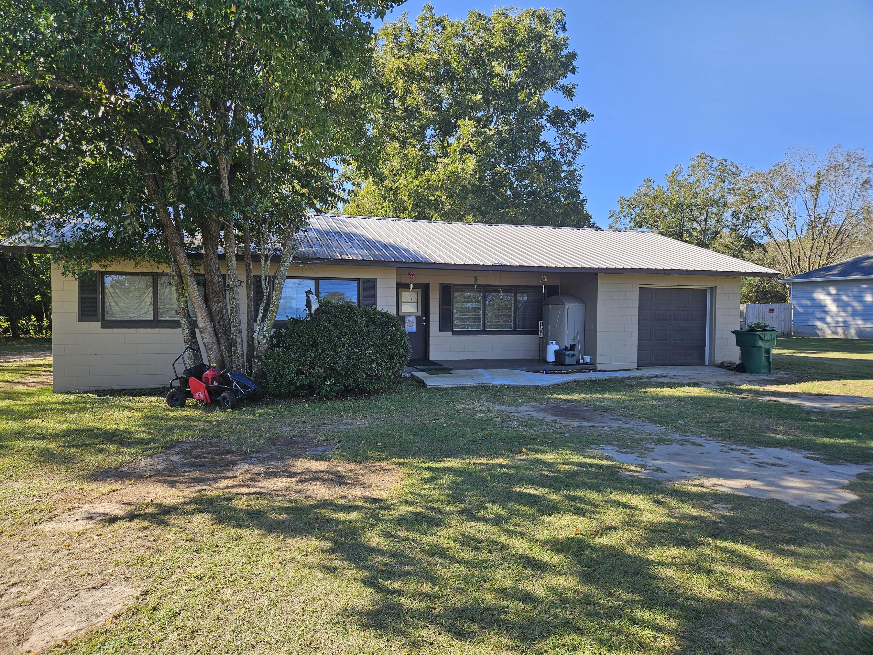 a view of a house with a yard and tree s