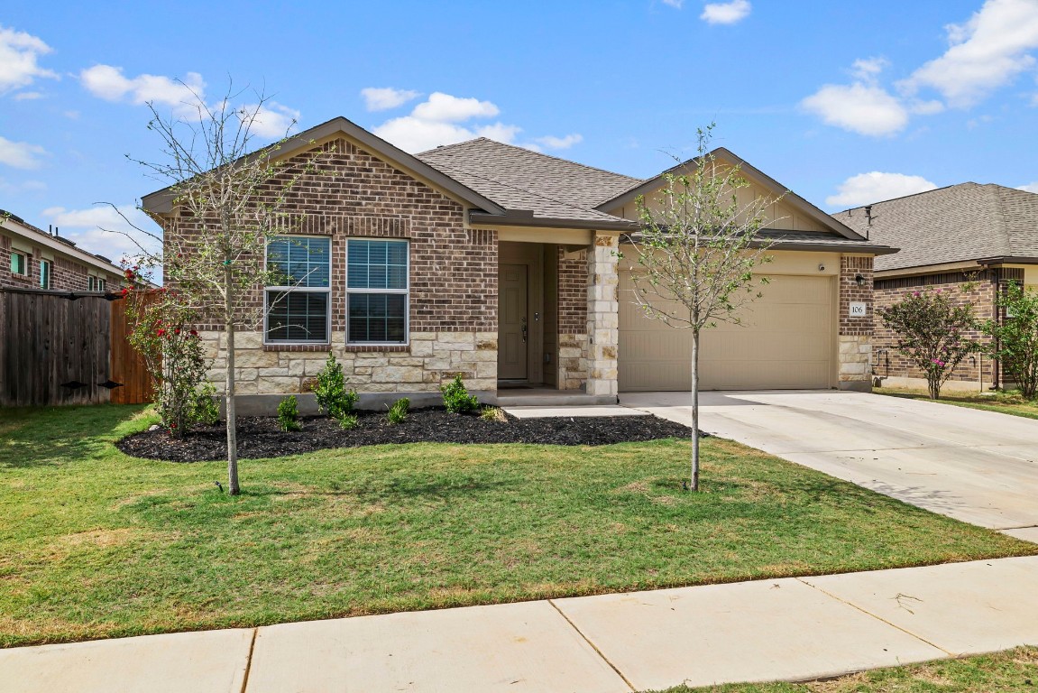 a front view of a house with a yard