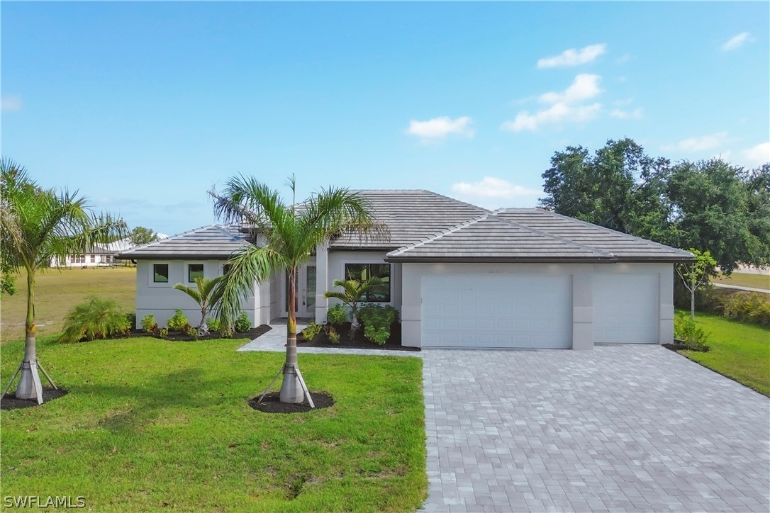 a front view of house with yard and green space