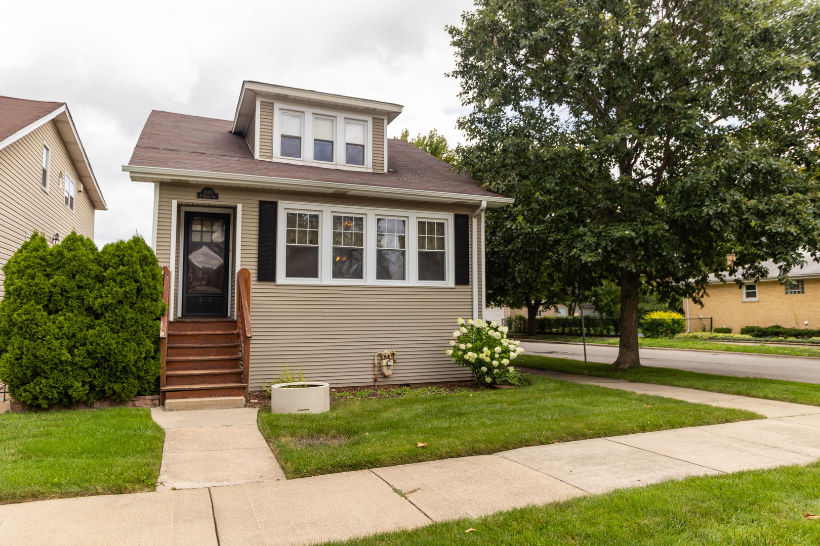 a front view of a house with garden