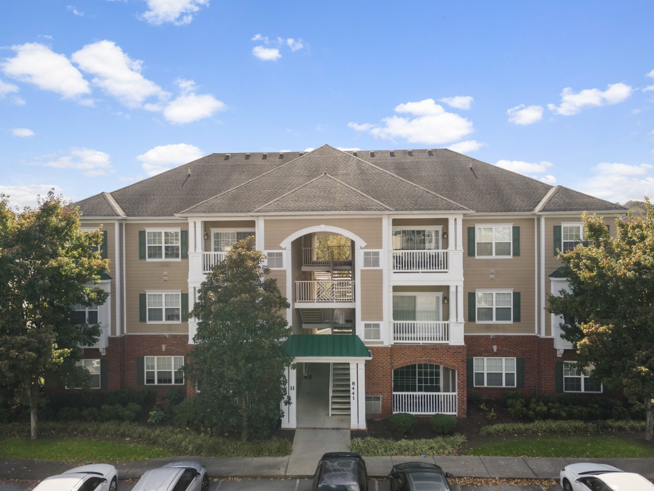 a front view of a residential apartment building with a yard