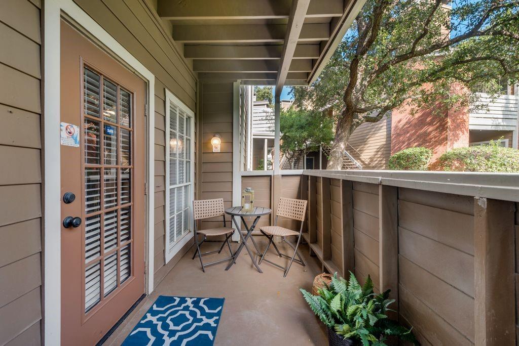 a view of balcony with chairs and potted plants