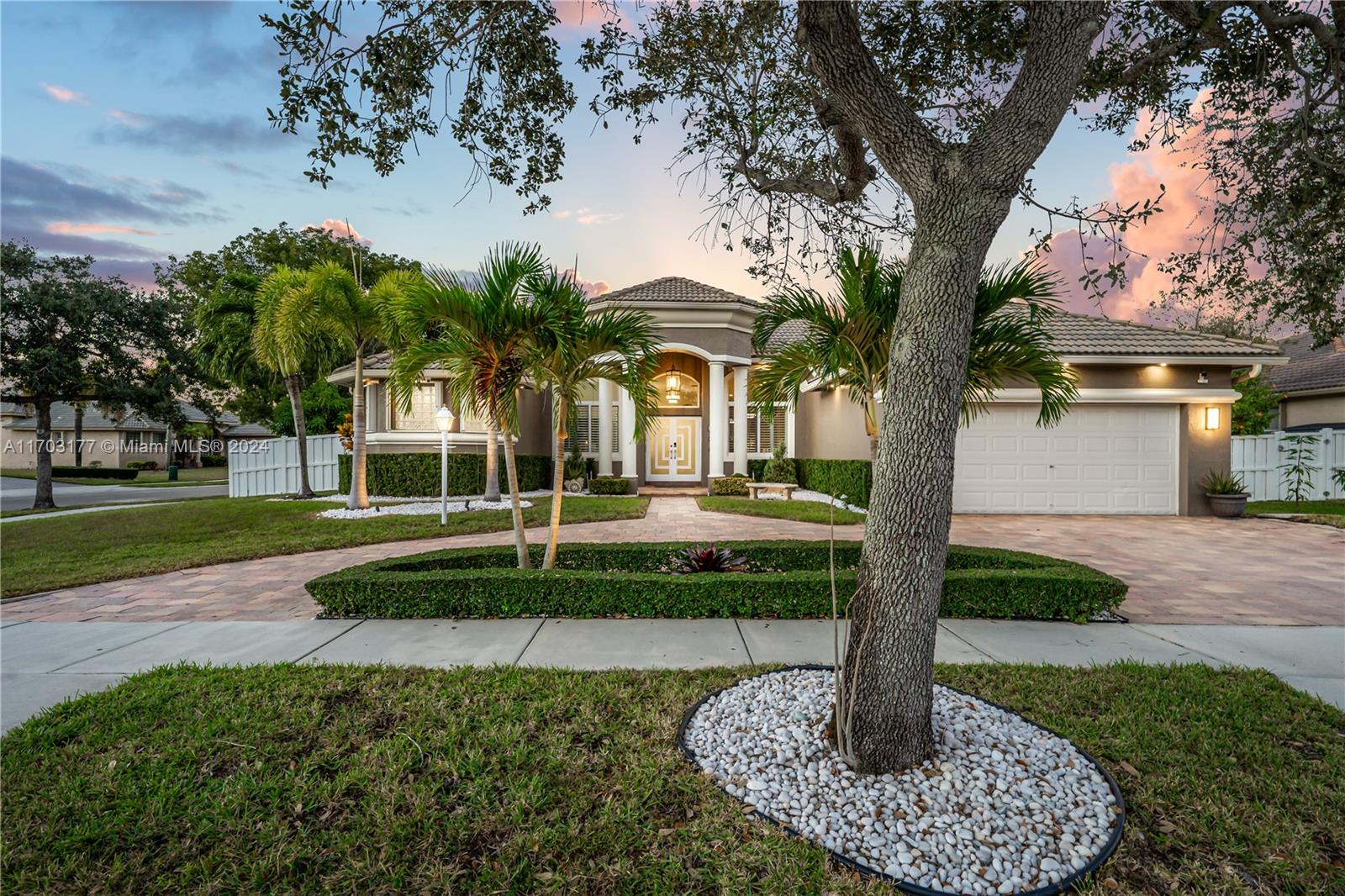 a front view of a house with a yard and fountain