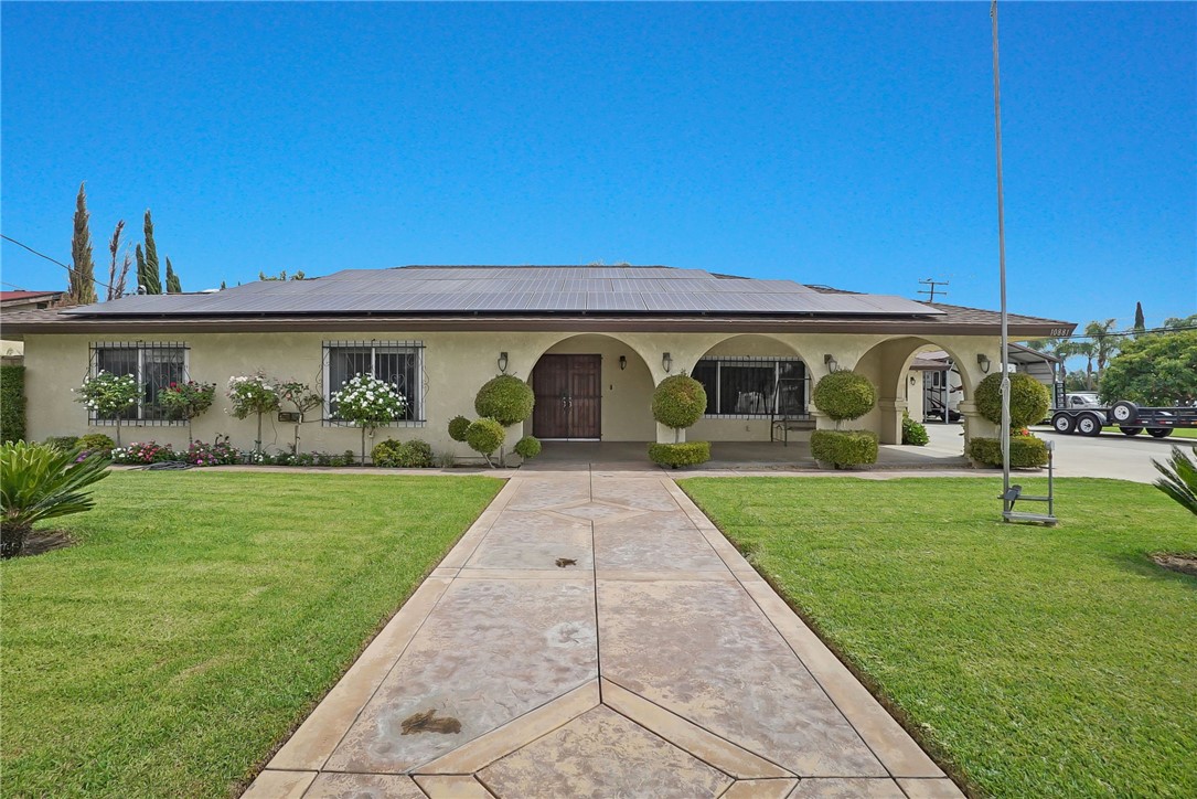 a front view of a house with garden