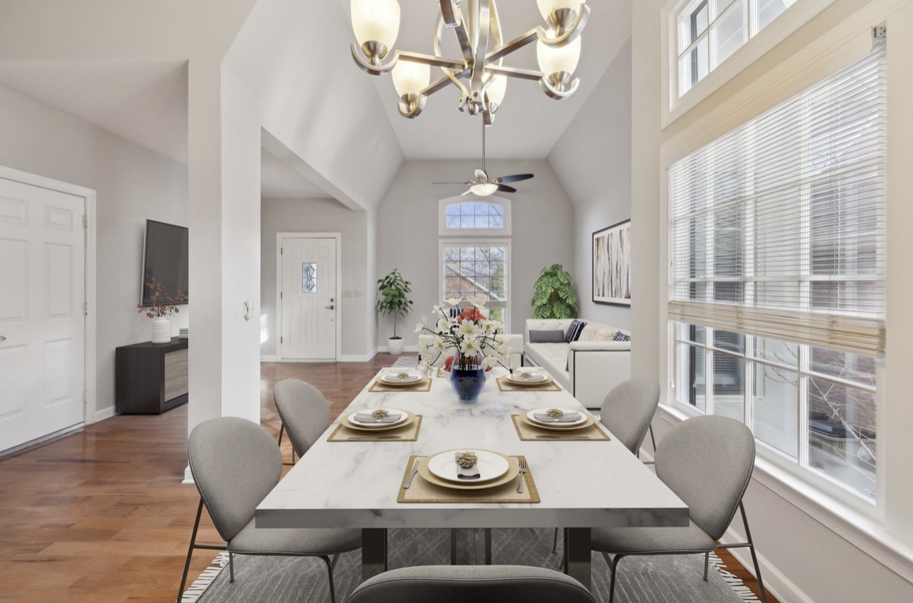 a view of a dining room with furniture a chandelier and wooden floor