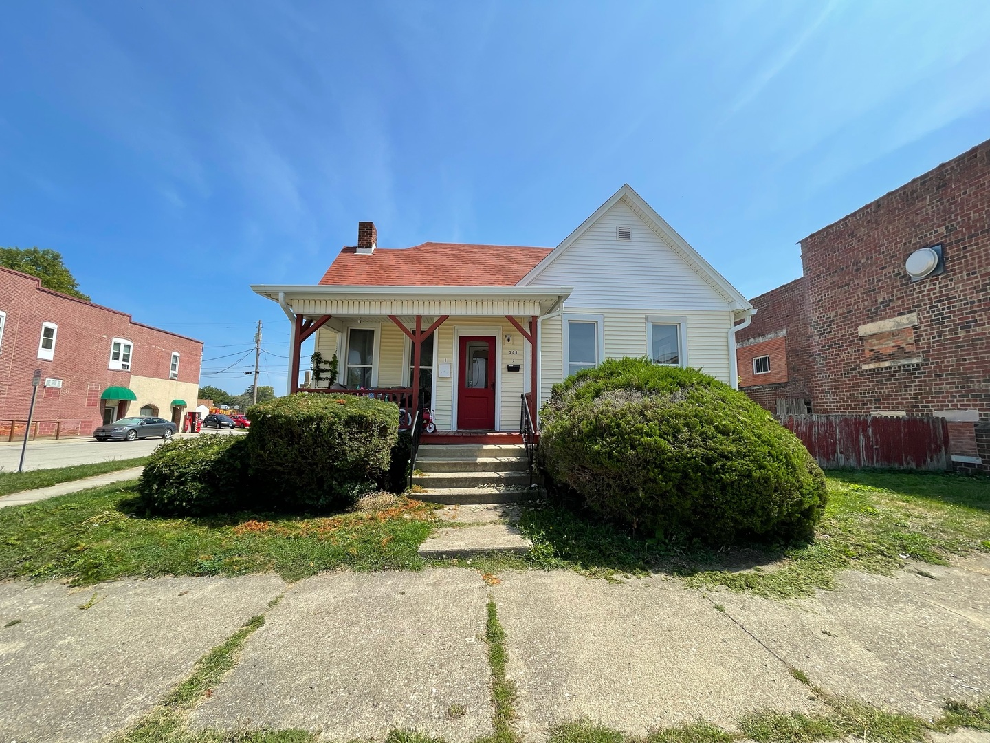 a front view of a house with a garden