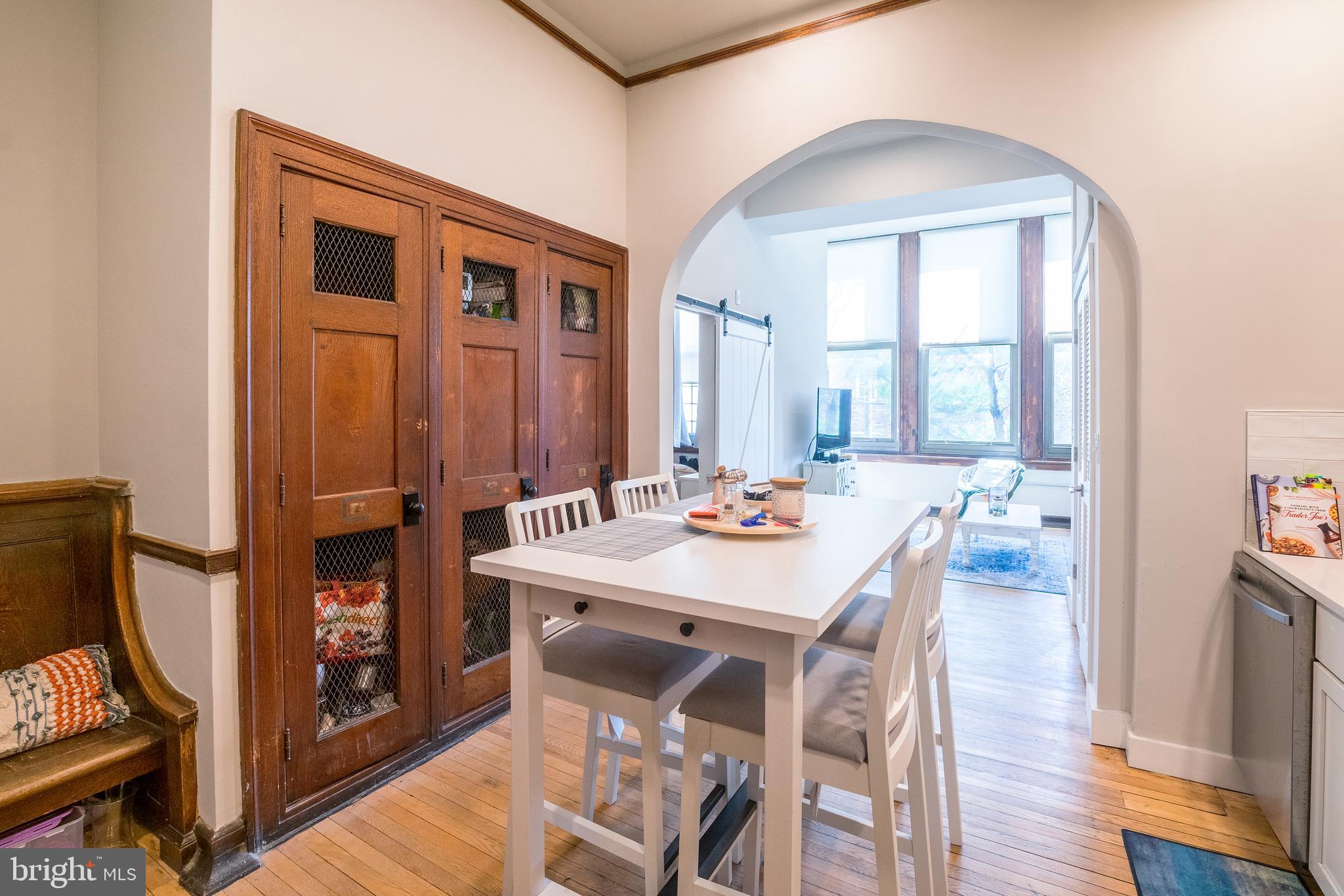 a view of a a dining room with furniture window and wooden floor