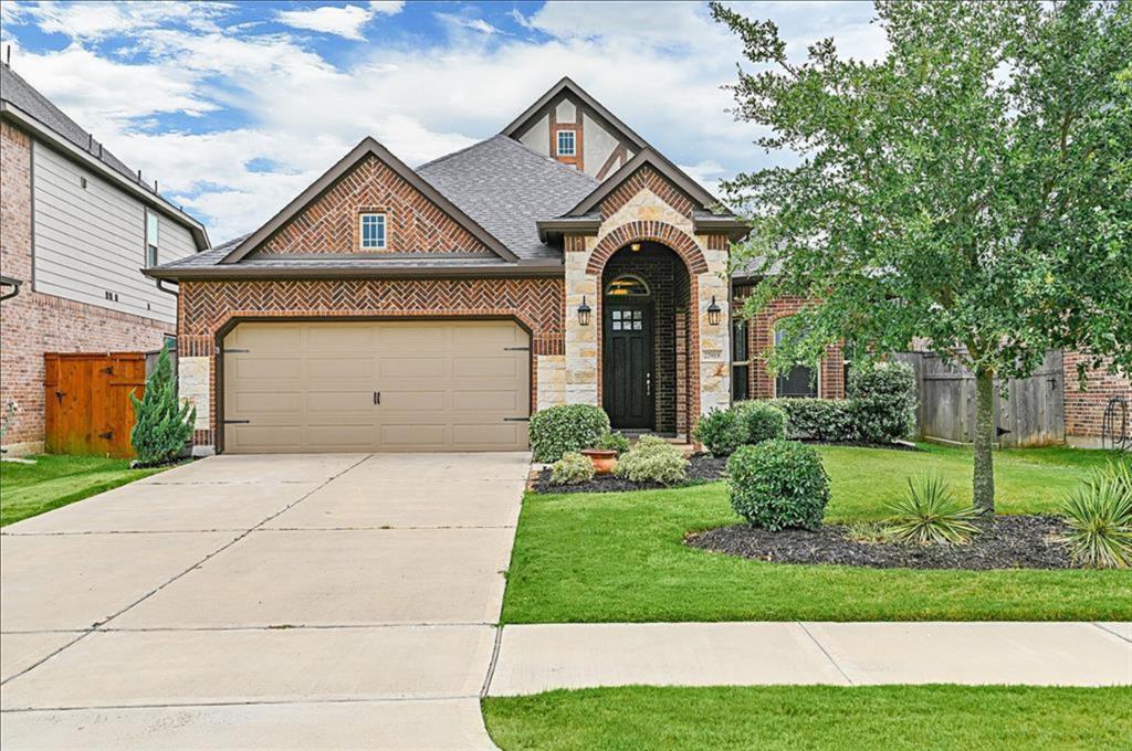 a front view of a house with a yard and garage