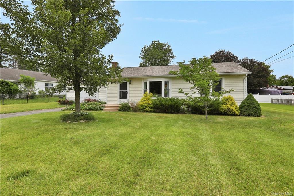 a view of a house with a backyard and a garden