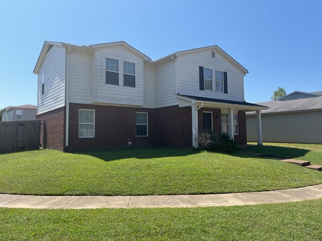 View of property with a front yard