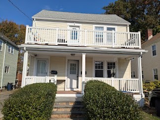 front view of a house with a yard