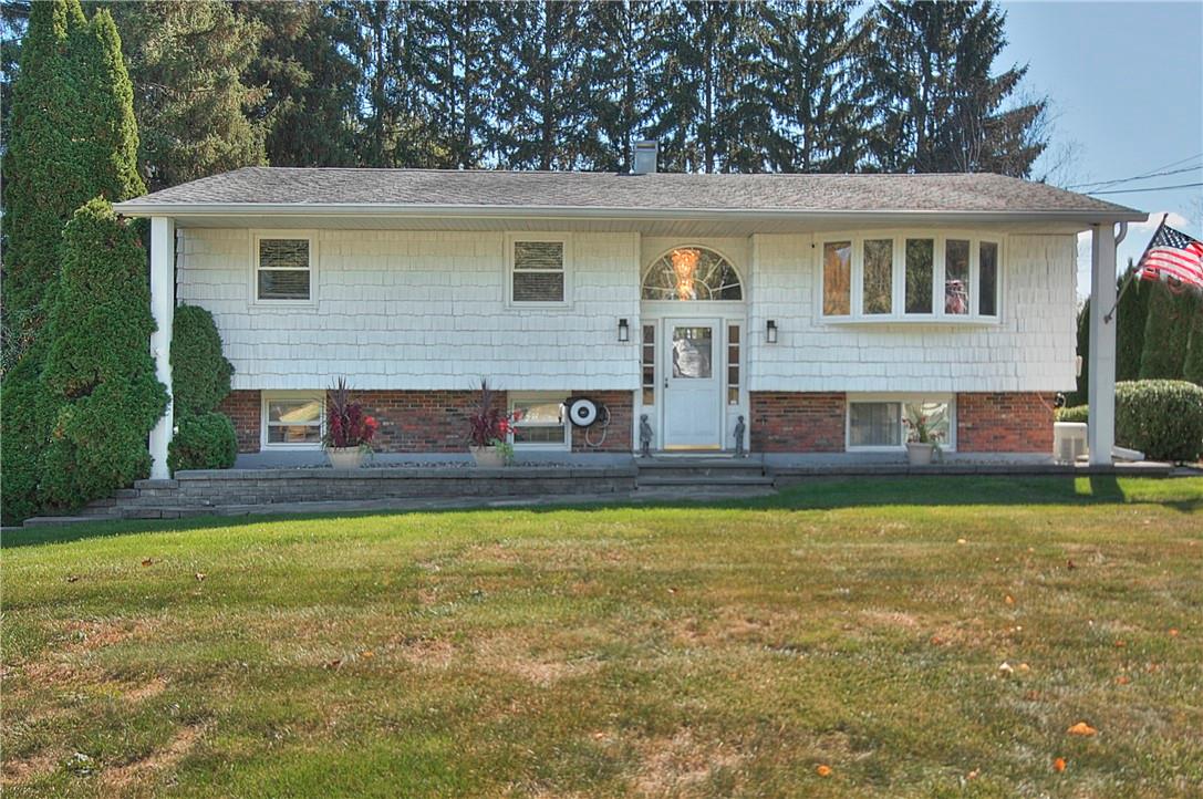 a view of house with a yard