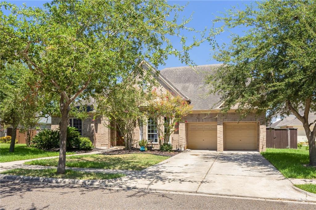 Obstructed view of property with a front yard and a garage