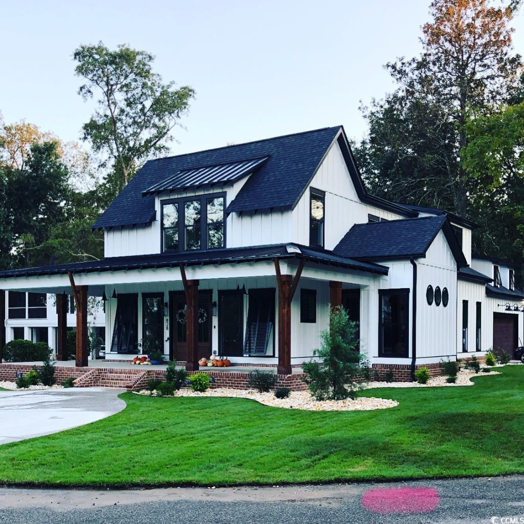 Modern inspired farmhouse with covered porch, a fr