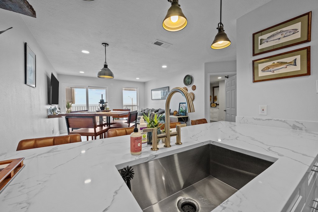 a kitchen with a sink appliances and cabinets