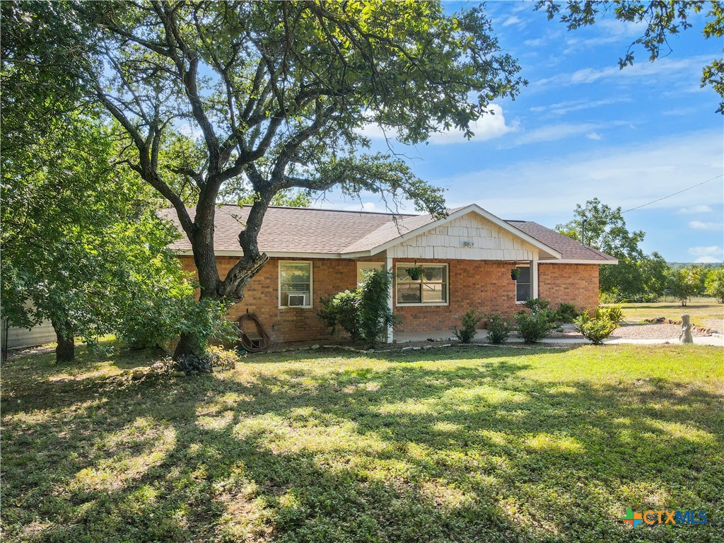 a front view of a house with yard and green space