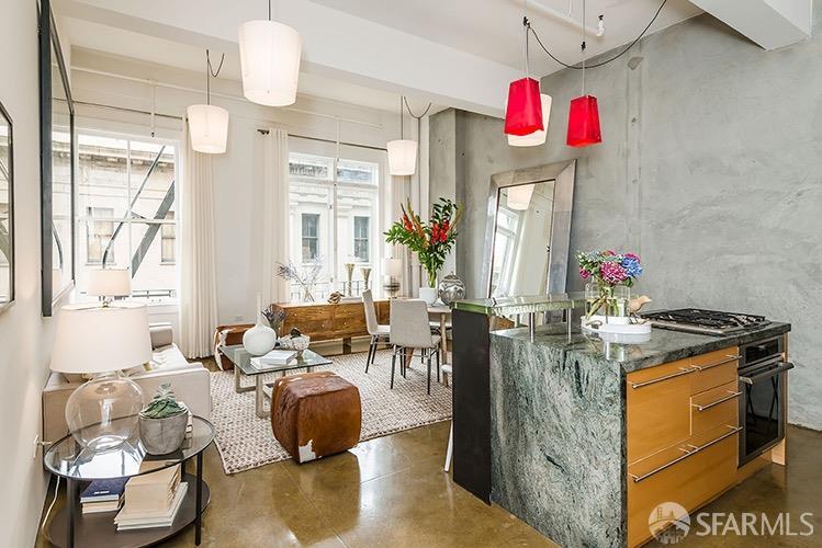 a living room with furniture a chandelier and a dining table