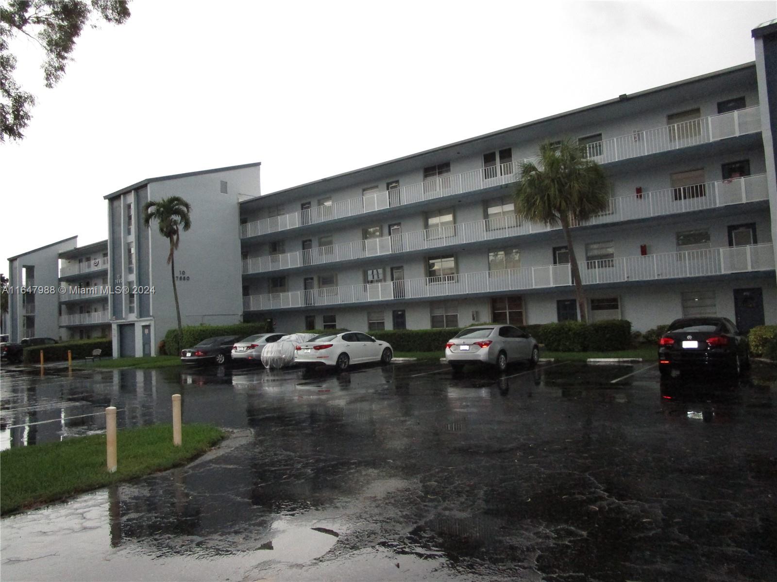 a couple of cars parked in front of a building