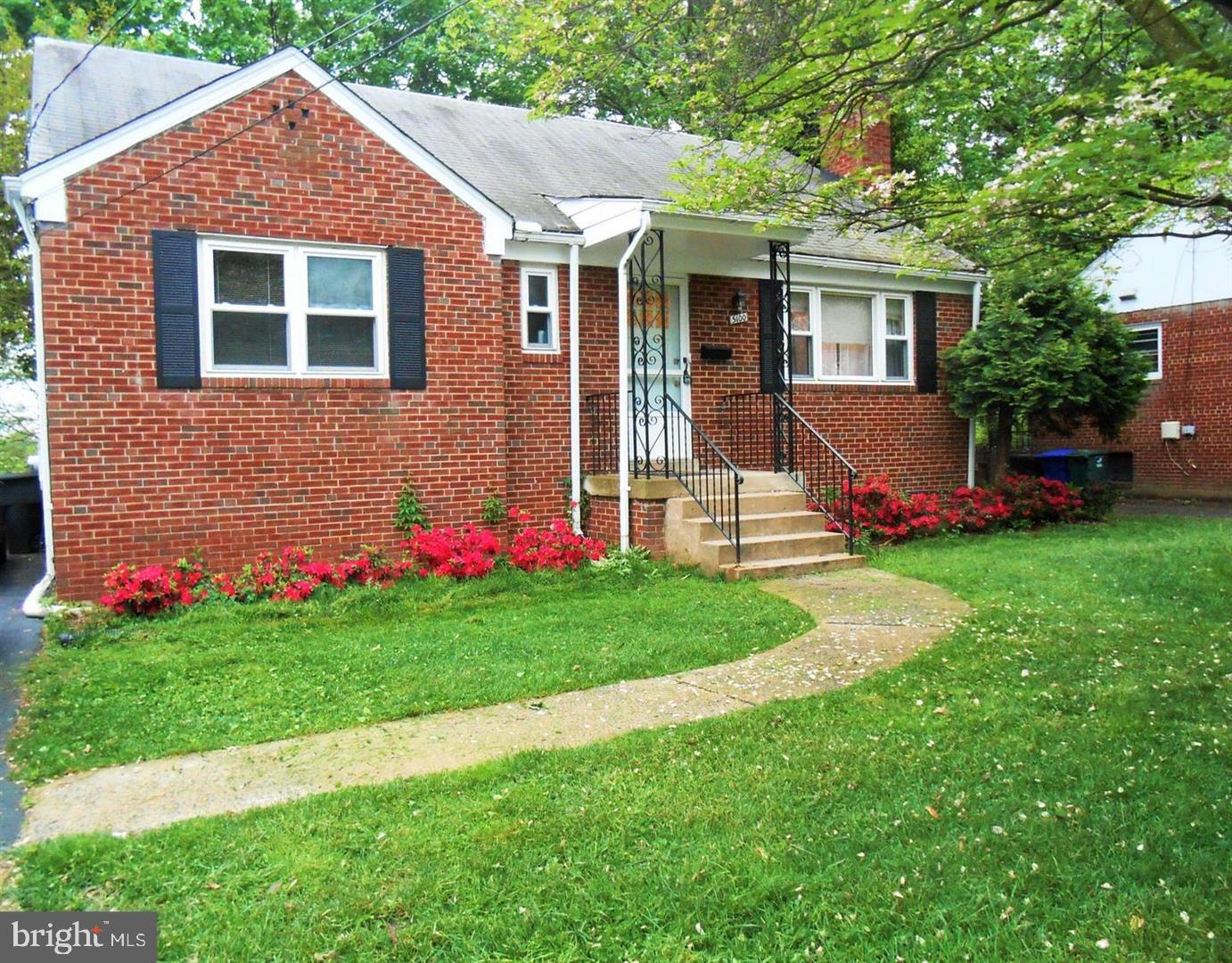 a view of a house with a yard and a garden